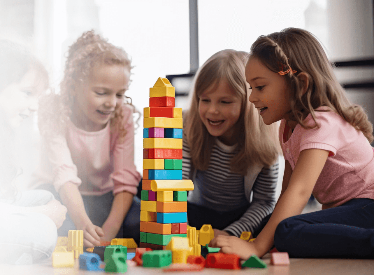 Children building a tower of colorful toy blocks together